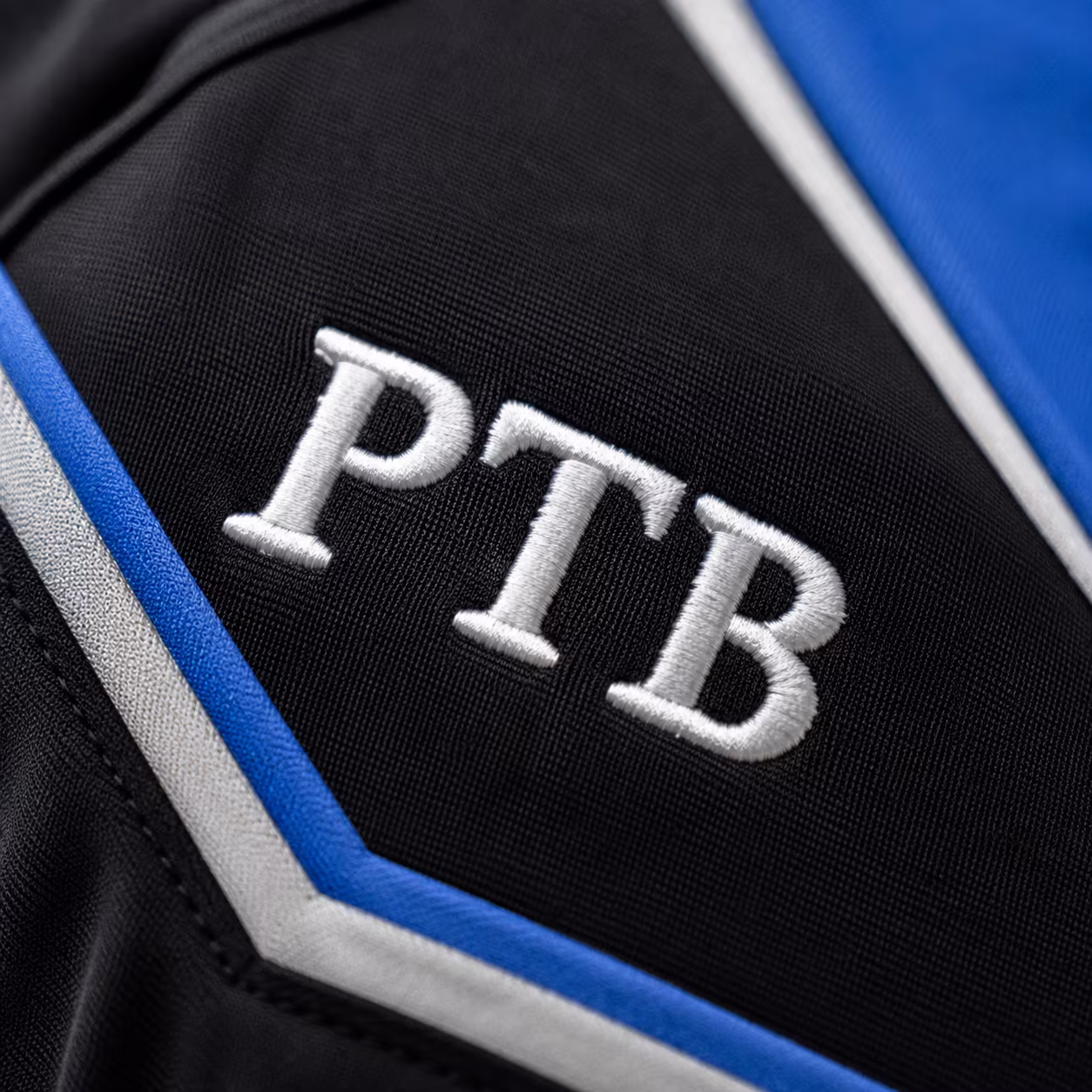 Close-up of the embroidered Prime Time Ballers logo on the black game uniform.