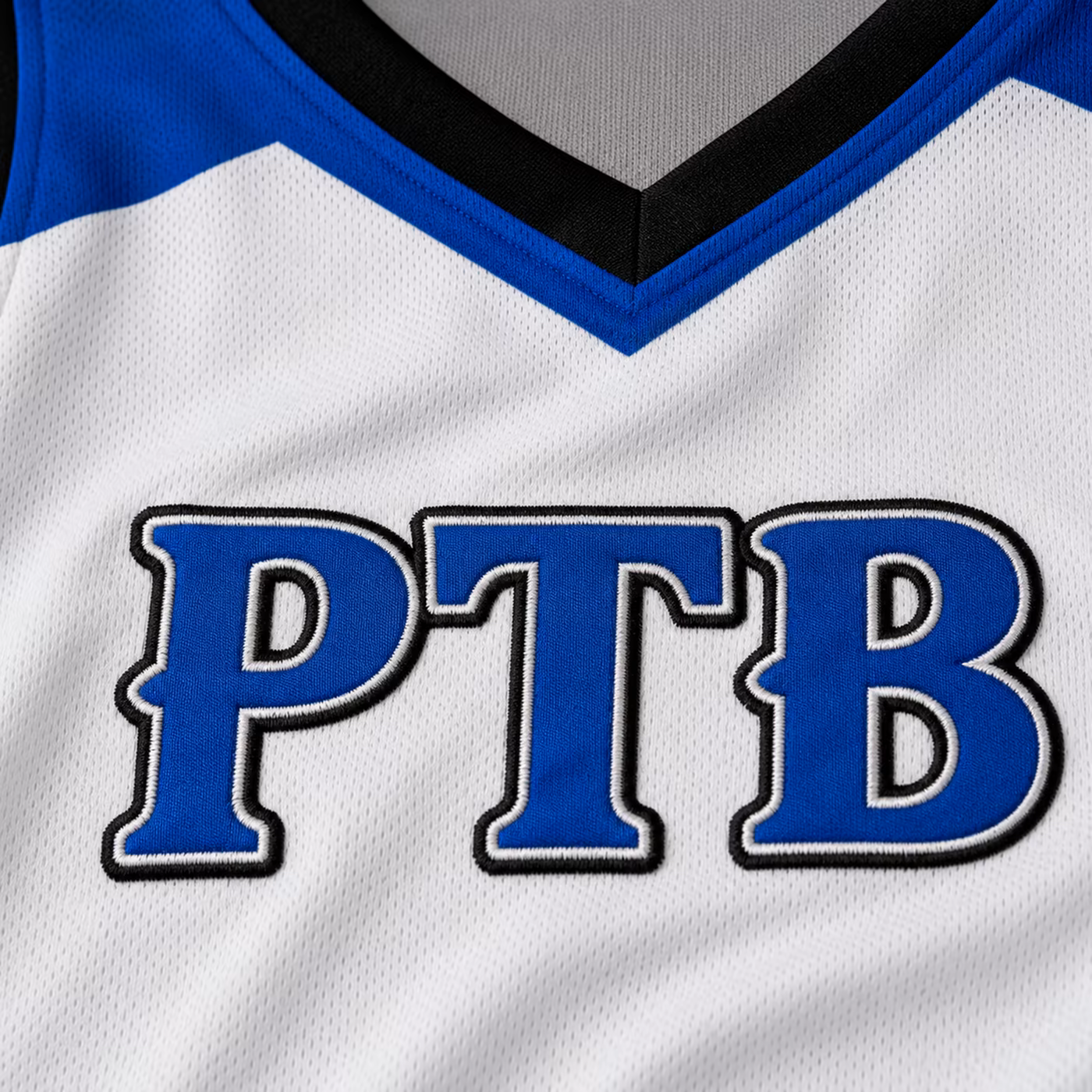 Close-up of the embroidered Prime Time Ballers logo on the white game uniform.